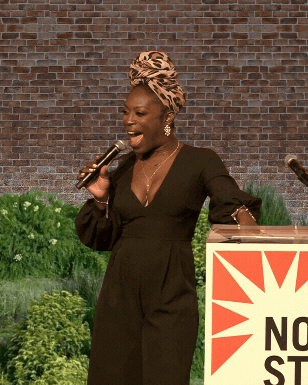 Kerry Coddett holding a microphone and laughing